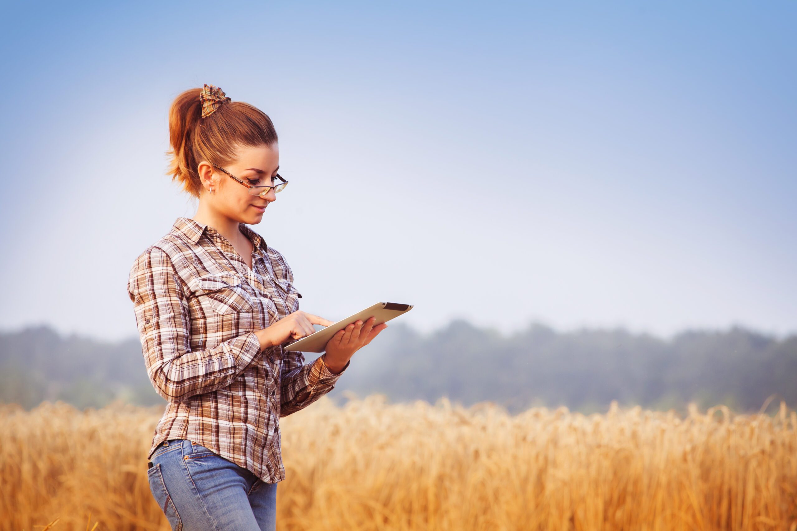Pretty,Farmer,Girl,In,Glasses,With,Hair,Tied,In,A boy in the field